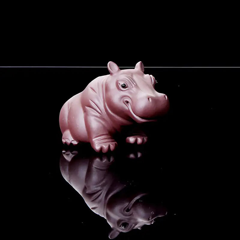 Smiling pink hippopotamus tea pet from Guardian of Still Waters, a charming yixing clay tea feng shui pet
