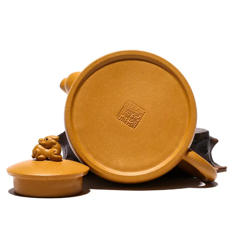 Yixing teapot with guardian beast lid and rabbit figurine made from golden duanni clay