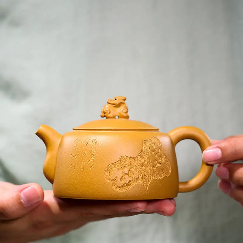 Yellow-brown Yixing teapot with guardian beast lid made of golden duanni clay