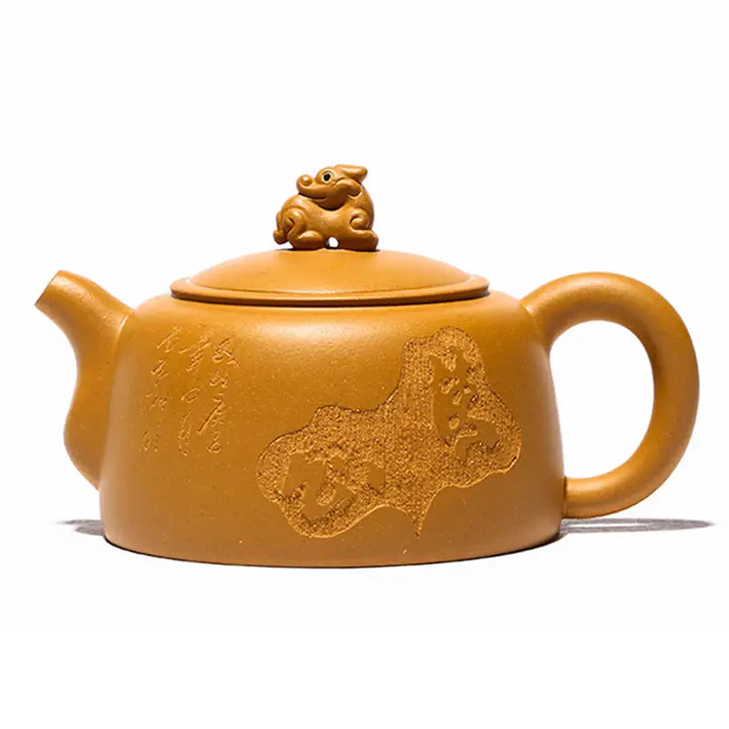 Earthenware Yixing teapot with guardian beast lid in golden Duanni clay featuring a sculpted animal