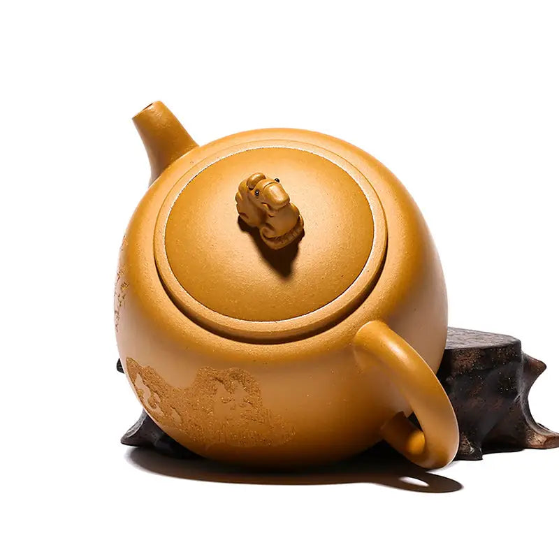Yellow-brown ceramic Yixing teapot with guardian beast lid handle in golden duanni clay
