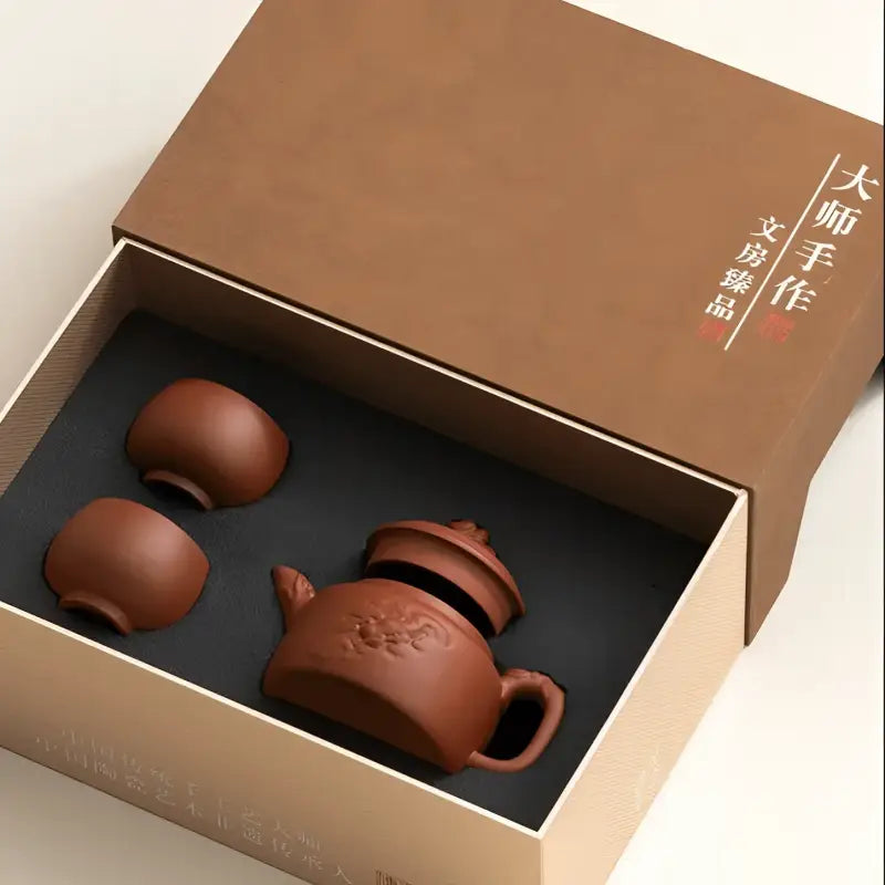 Brown clay Yixing Zisha Guardian Spirit Tea Set with handcrafted teapot and cups in a box