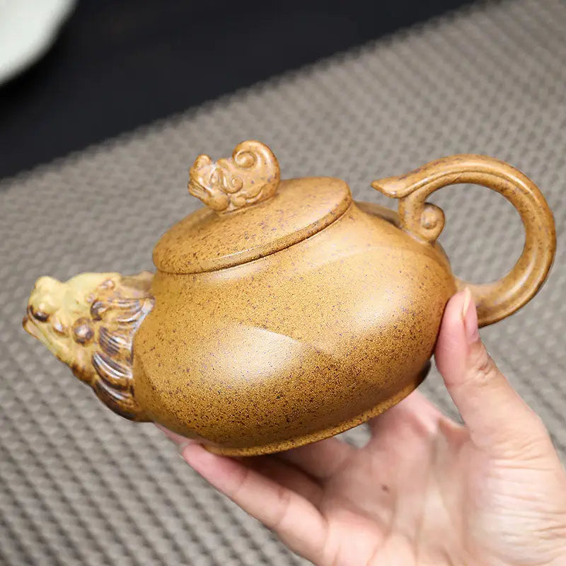 Ornate brown Yixing teapot with lion head spout crafted from duanni clay in Guardian Spirit