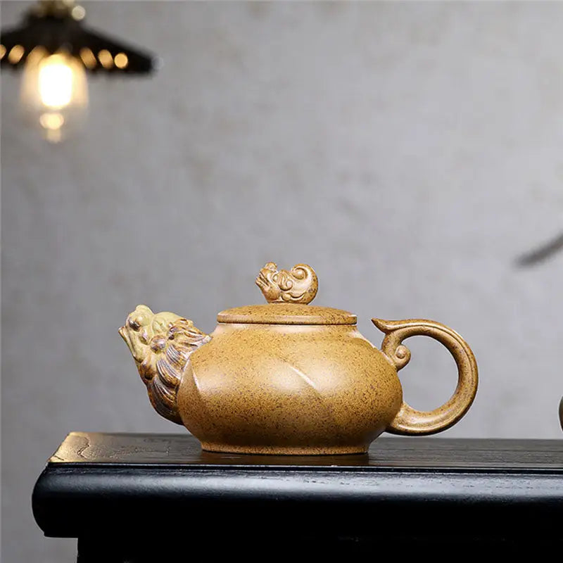 Ornate tan yixing teapot with lion head spout from Guardian Spirit made of duanni clay