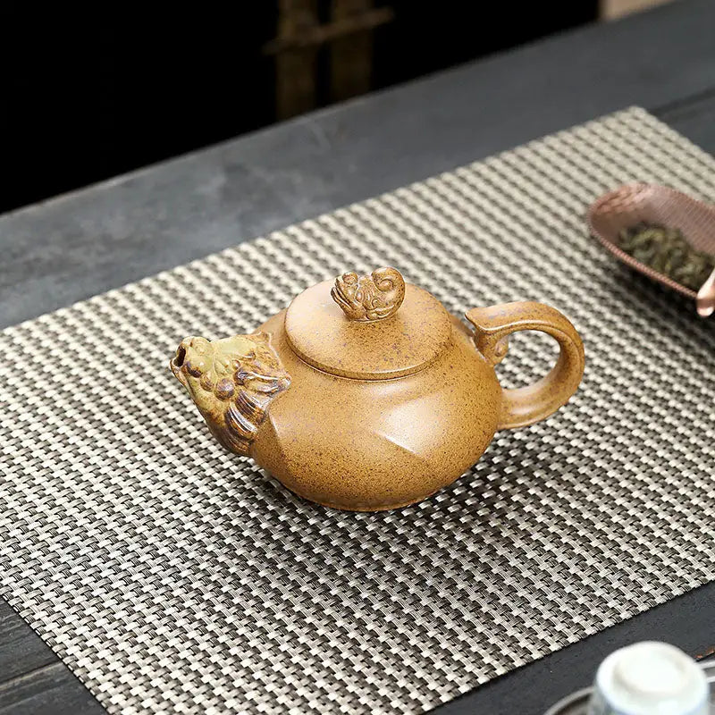Ornate brown yixing teapot with lion head spout made of duanni clay in Guardian Spirit product