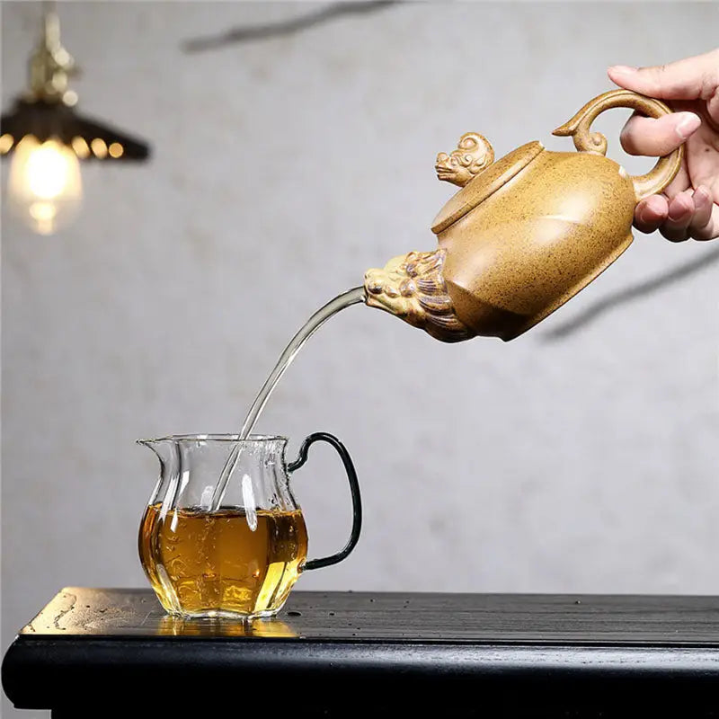 Yixing teapot Guardian Spirit with lion head spout pouring tea crafted from duanni clay