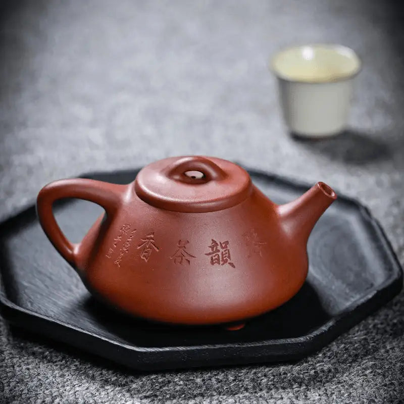 Reddish-brown Yixing Zisha teapot from Guqin Reverie featuring a rounded body