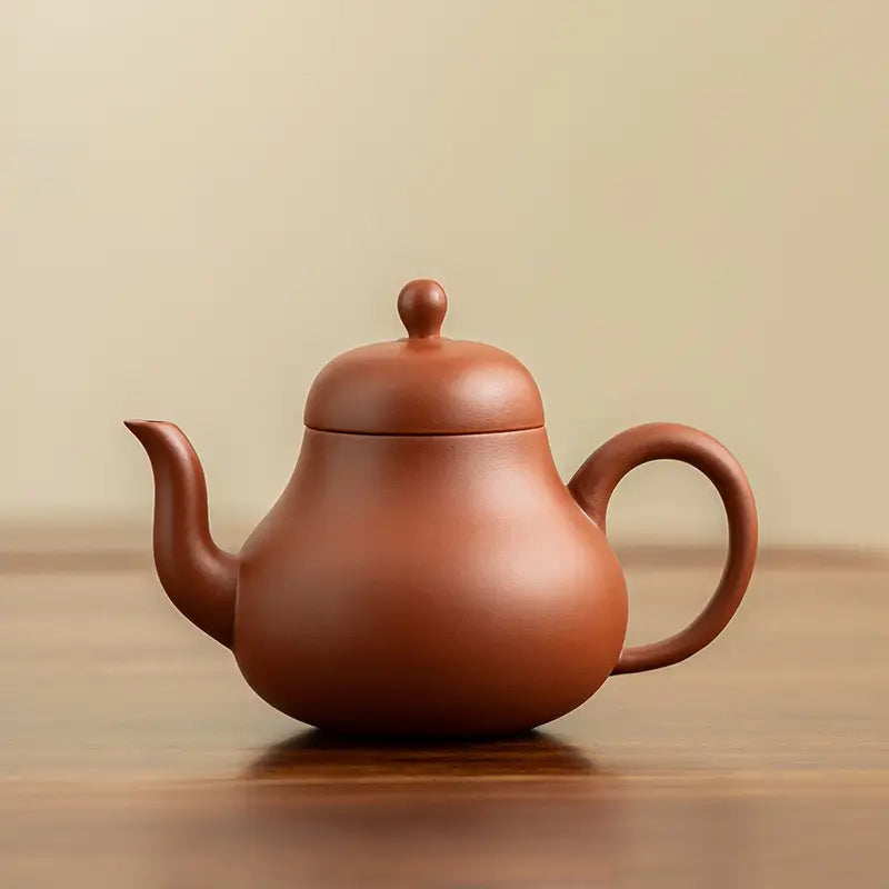 Earthenware Harmony Bloom Teapot with rounded body showcasing Yixing Zisha craftsmanship