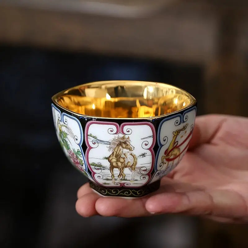 Ornate porcelain teacup with gilded interior from the Harmony tea set featuring elegant teapots