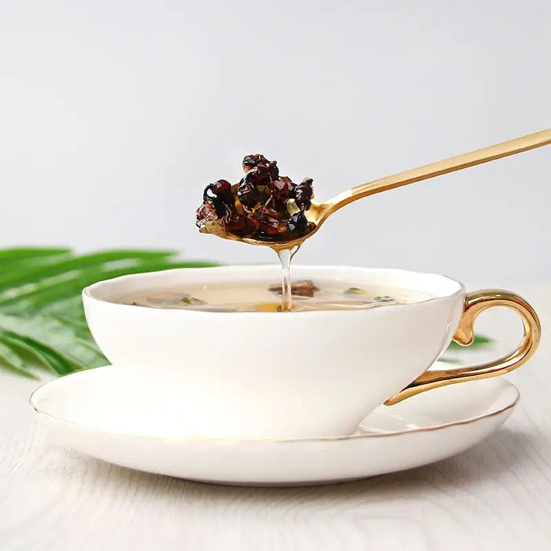 White teacup with golden accents from Health-Enhancing Herbal Tea featuring Hovenia Dulcis and Tangerine Peel