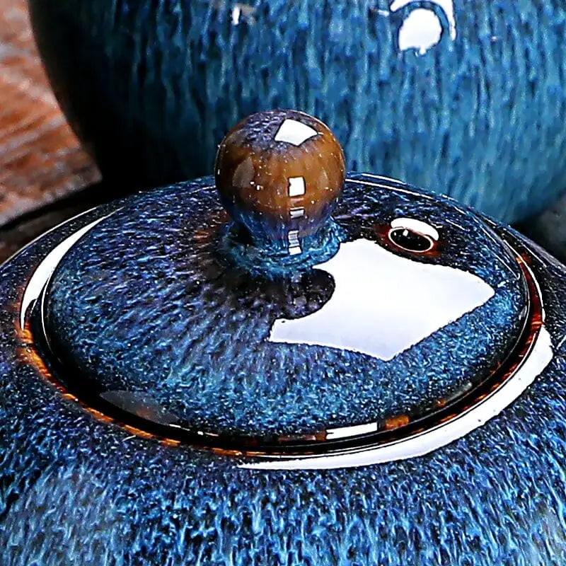Blue ceramic teapot lid with brown knob for Iceberg Teapot featuring Jian ware design