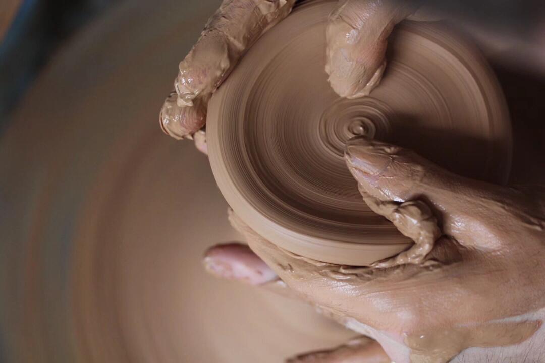 Dehua porcelain handcrafted clay being shaped on a pottery wheel in Fujian Province