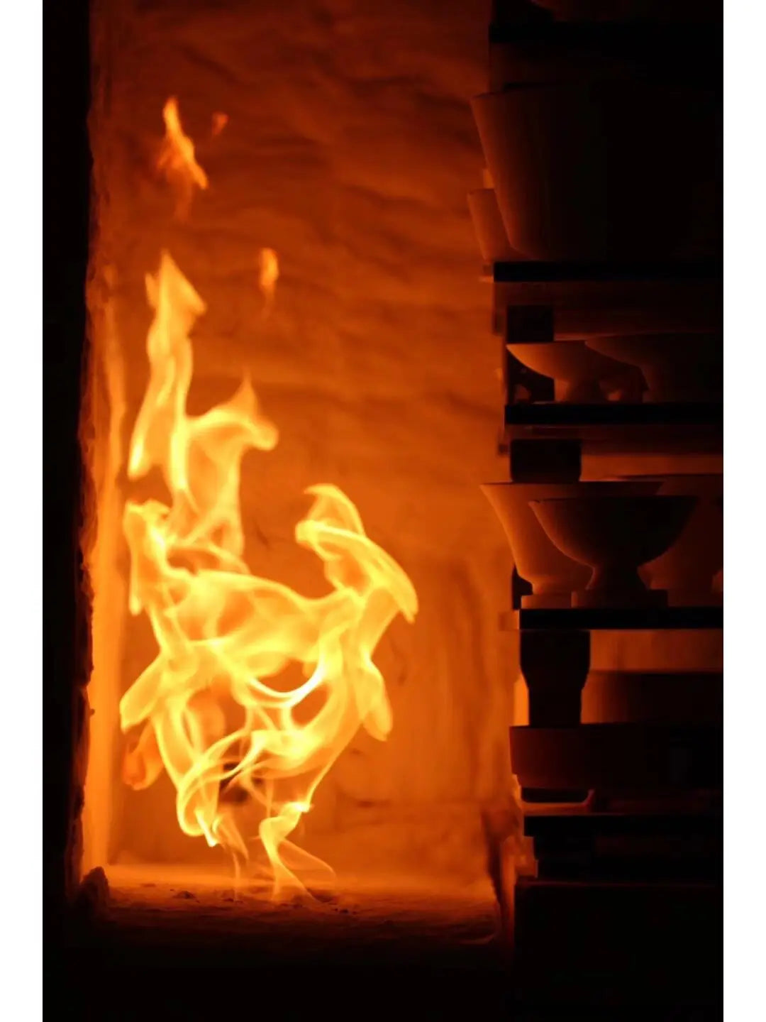 Fiery kiln with pottery showcasing Dehua porcelain, Chinese ceramic art from Fujian Province