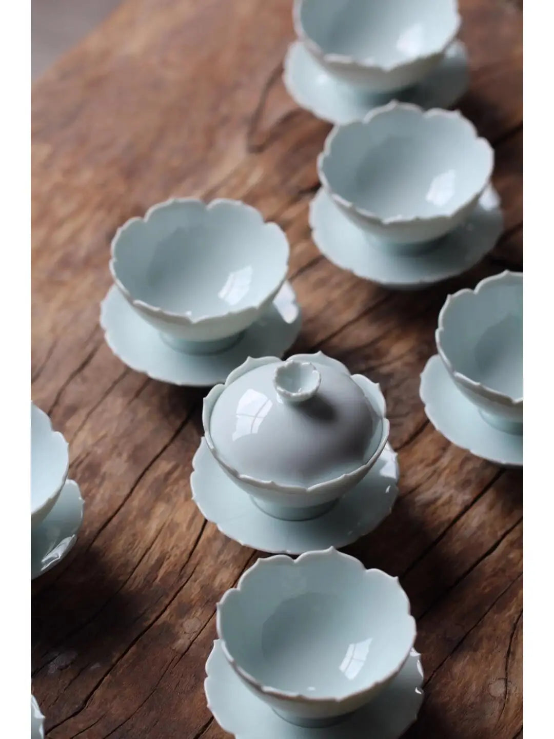 Delicate celadon teacups with floral rims showcasing Dehua porcelain from Fujian province