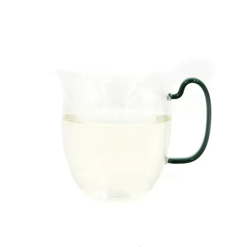 Glass mug with green handle showcasing Imperial Baihao Yinzhen white tea 2025
