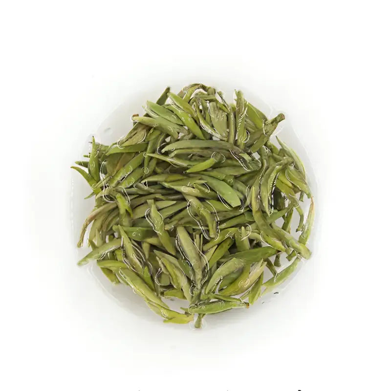 Pile of dried green tea leaves for Imperial Baihao Yinzhen White Silver Needle Tea