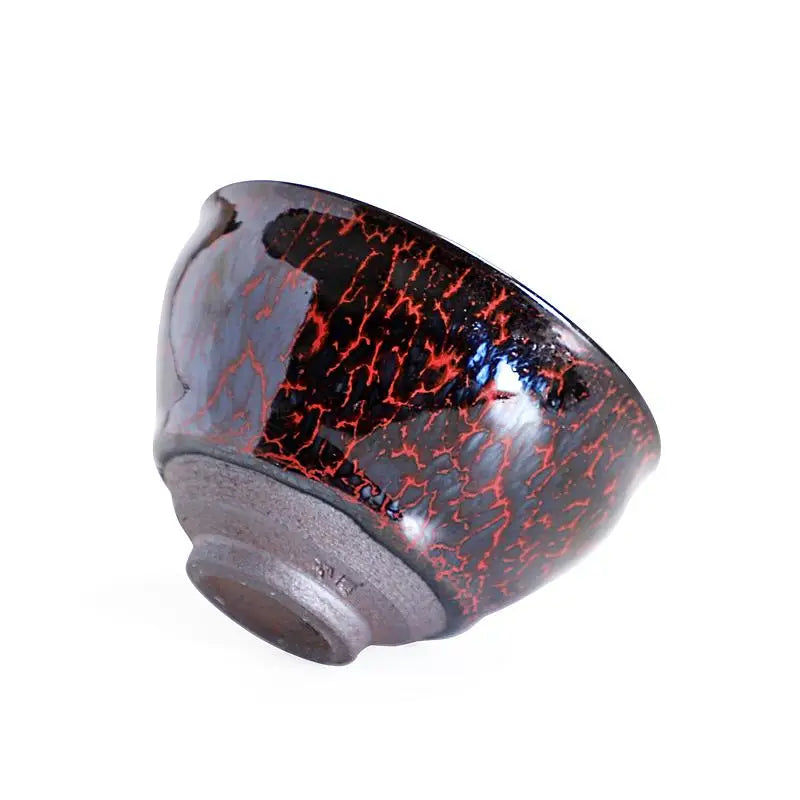 Black and red crackle-glazed ceramic bowl from Inferno Jian Zhan with red flame glaze