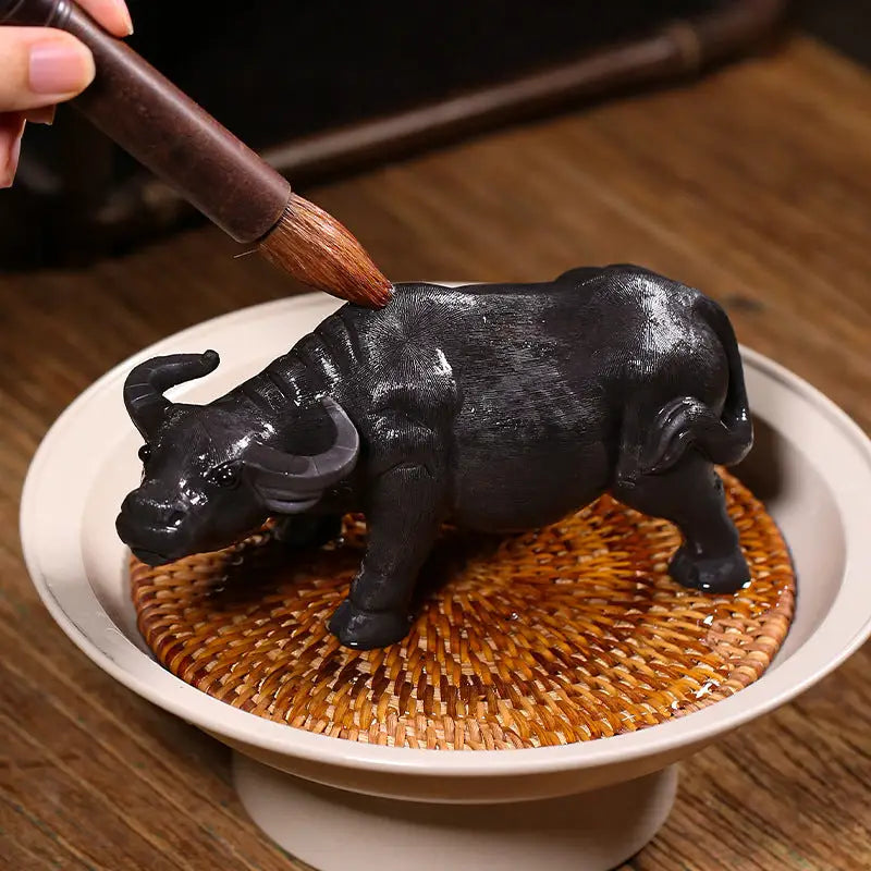Black buffalo figurine from Ironhoof Guardian water buffalo tea product, perfect tea pet guide