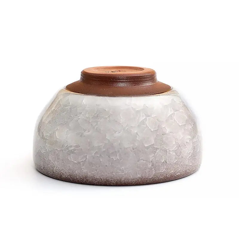 Textured ceramic bowl with brown base featuring Ivory Rift crackled glaze and crackled grape teacup style