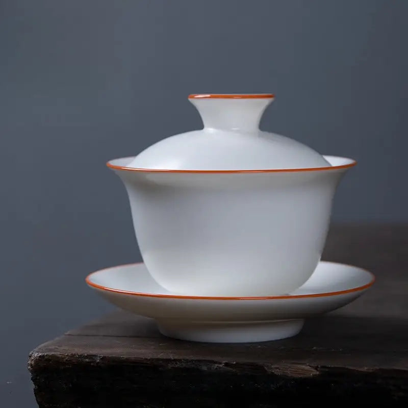 White ceramic gaiwan with orange trim in Ivory White Ru Kiln, made from dehua porcelain