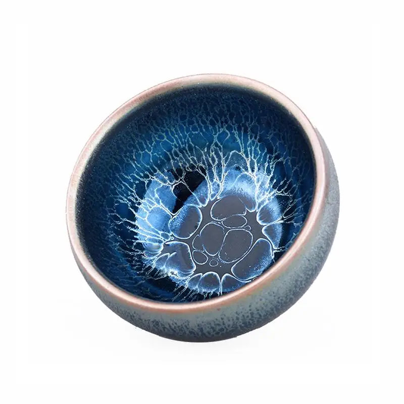 Blue ceramic bowl with unique glaze showcasing a tenmoku jian zhan crystalline bloom tea bowl