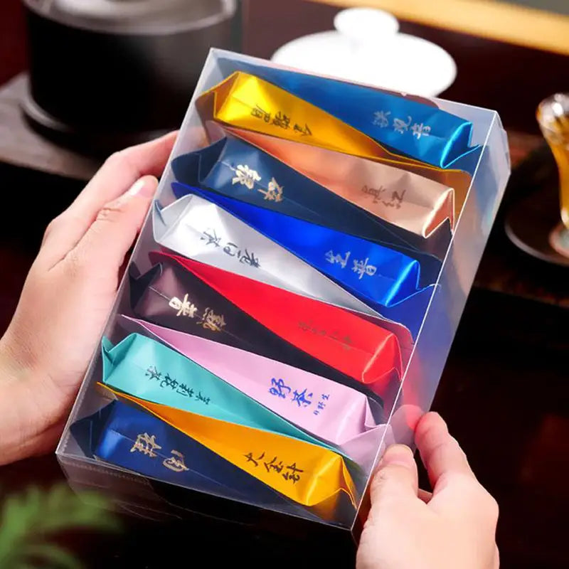 Box of colorful tea packets from Jin Jun Mei Jasmine Tea Cinnamon Black Tea Rock Tea for tea lovers