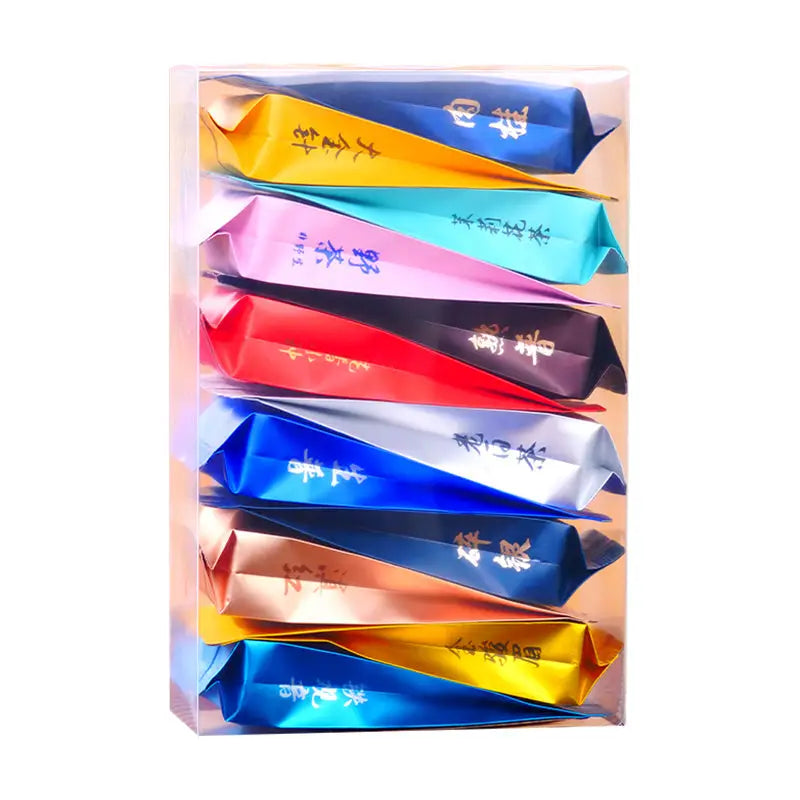 Colorful tea packets in a clear box for Jin Jun Mei Jasmine Tea Cinnamon Black Tea Rock Tea