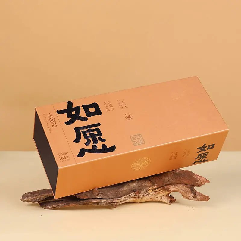 Rectangular tan box containing Jin Jun Mei Red Tea Leaves ideal for tea sets and mugs