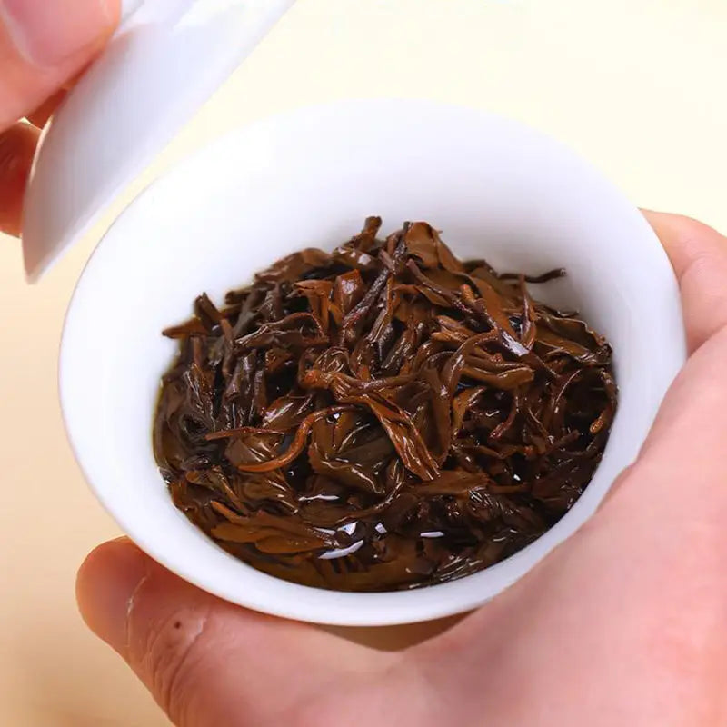Dark steeped Jin Jun Mei Red Tea Leaves in a teapot, perfect for tea sets and mugs