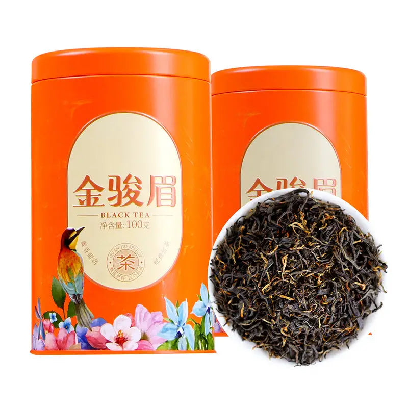 Orange tea tins with loose black tea for Jin Jun Mei Red Tea Leave in elegant teapots and mugs