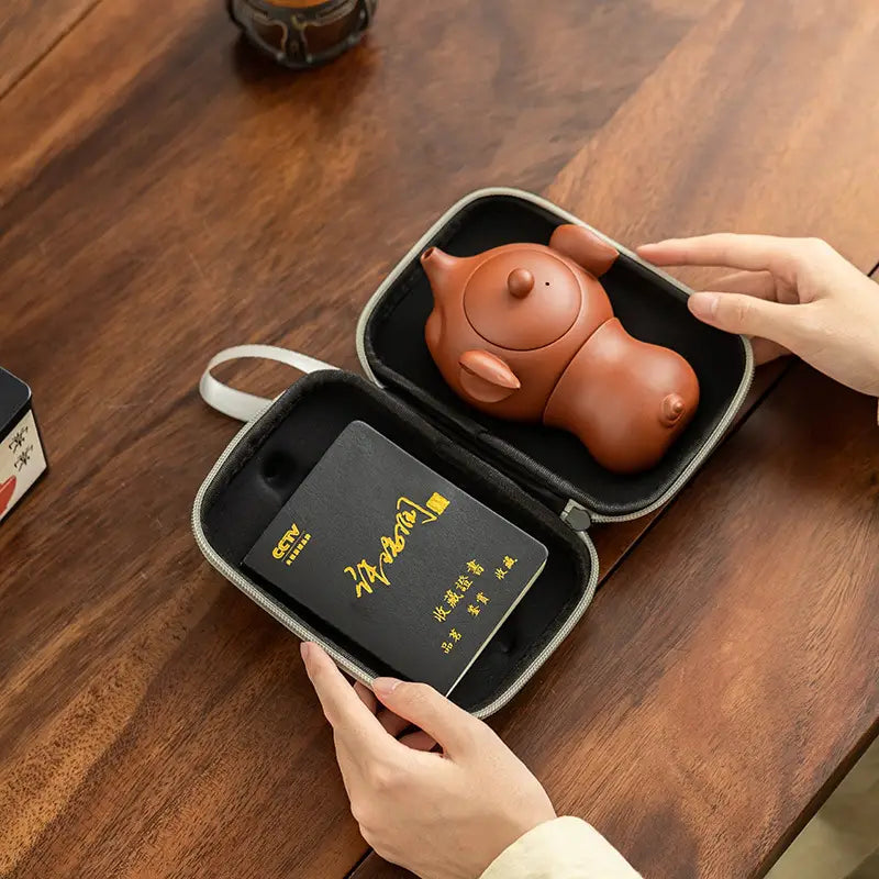 Brown Yixing Zisha teapot in Joyful Piglet Tea Set carrying case for tea lovers