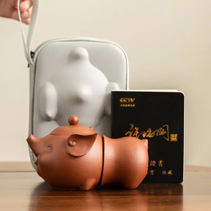 Joyful Piglet Yixing Zisha Teapot Set featuring a pig-shaped brown teapot