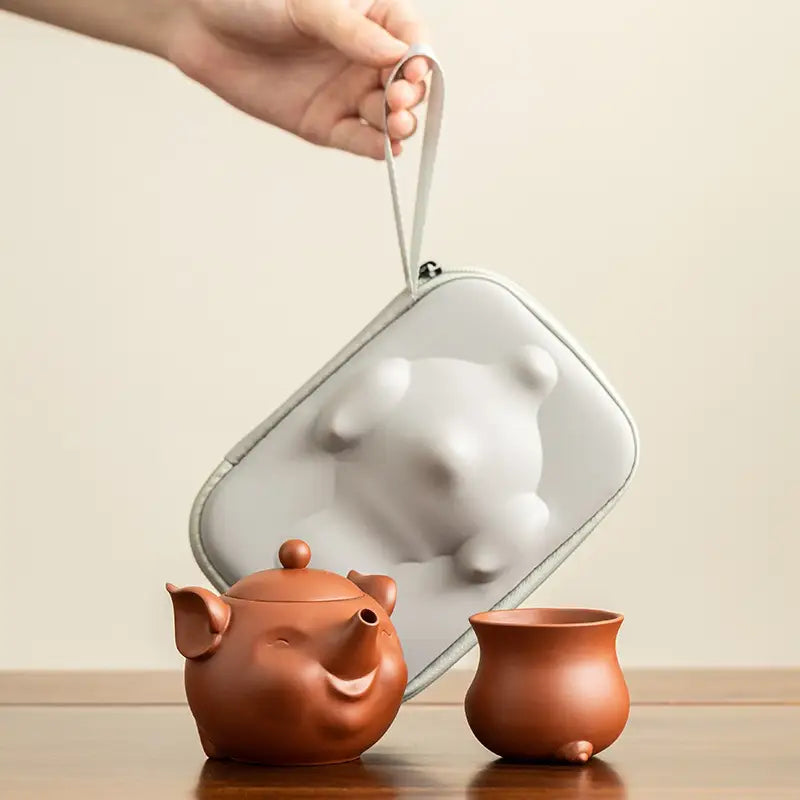 Joyful Piglet Yixing Zisha teapot set with pig-shaped teapot and cup in carrying case