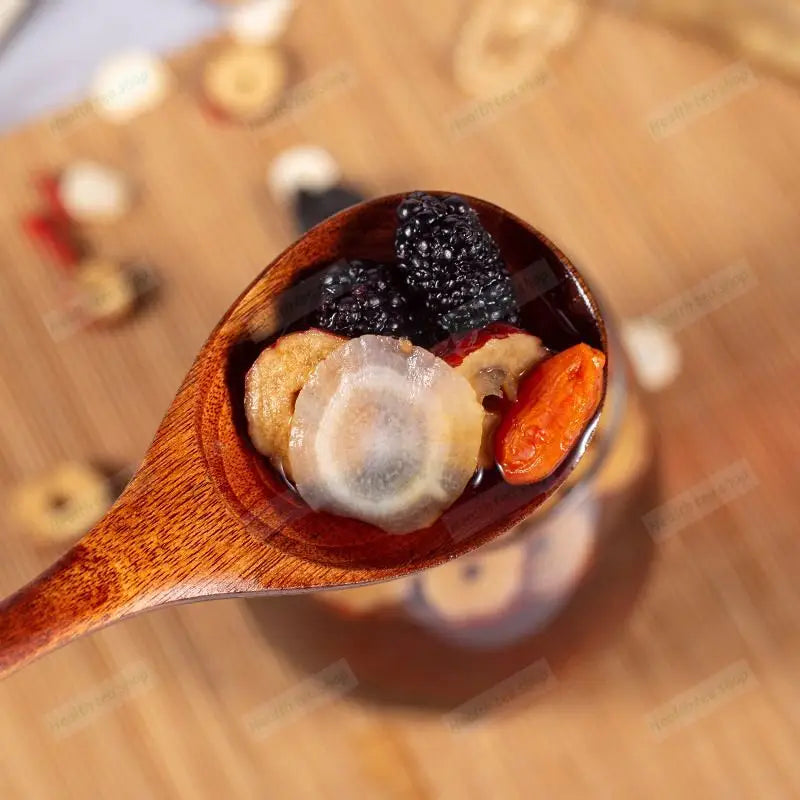 Wooden spoon with dried fruit and broth for kidney protection and reducing fatigue