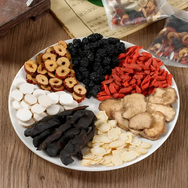 Assorted dried medicinal ingredients on plate for kidney protection and reducing fatigue