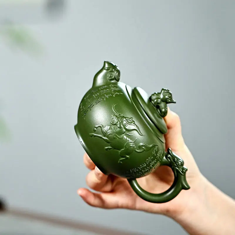 Green carved teapot from Kirin & Dragon featuring jianshui zitao purple pottery teapots