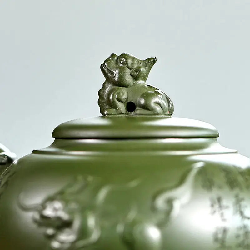 Green ceramic teapot with lion-shaped lid handle from Kirin & Dragon, perfect jianshui zitao teapots
