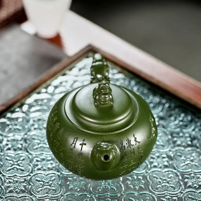 Green ceramic jianshui zitao teapot with small figure on lid from Kirin & Dragon collection