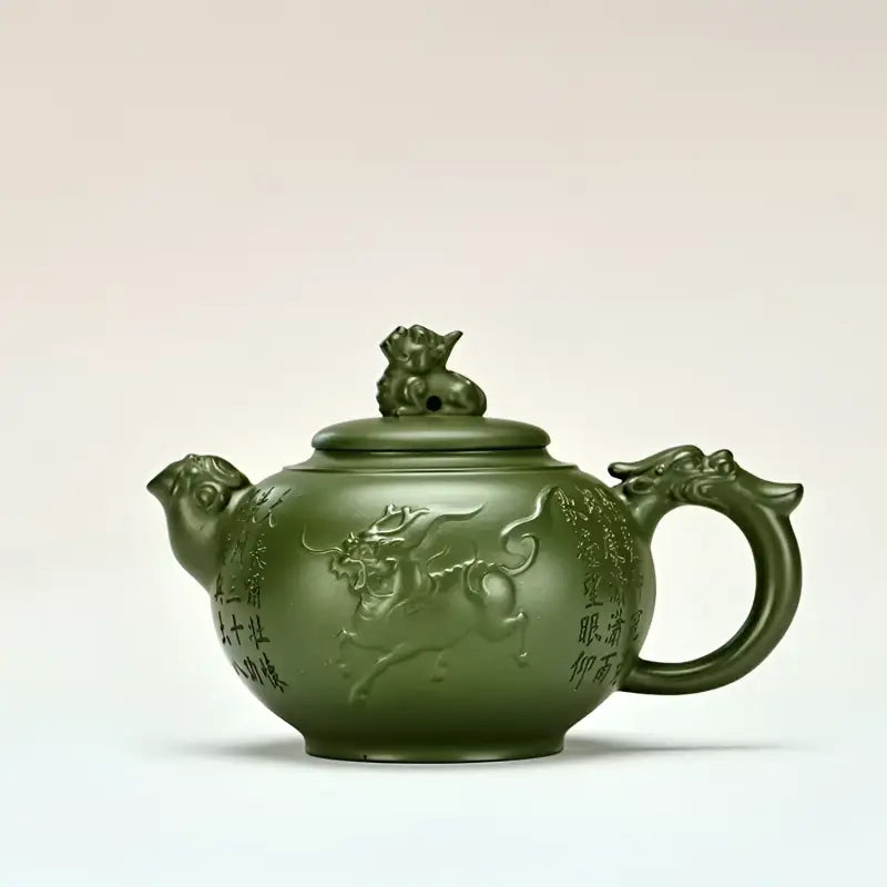 Green jianshui zitao ceramic teapot with dragon handle and bull relief from Kirin & Dragon