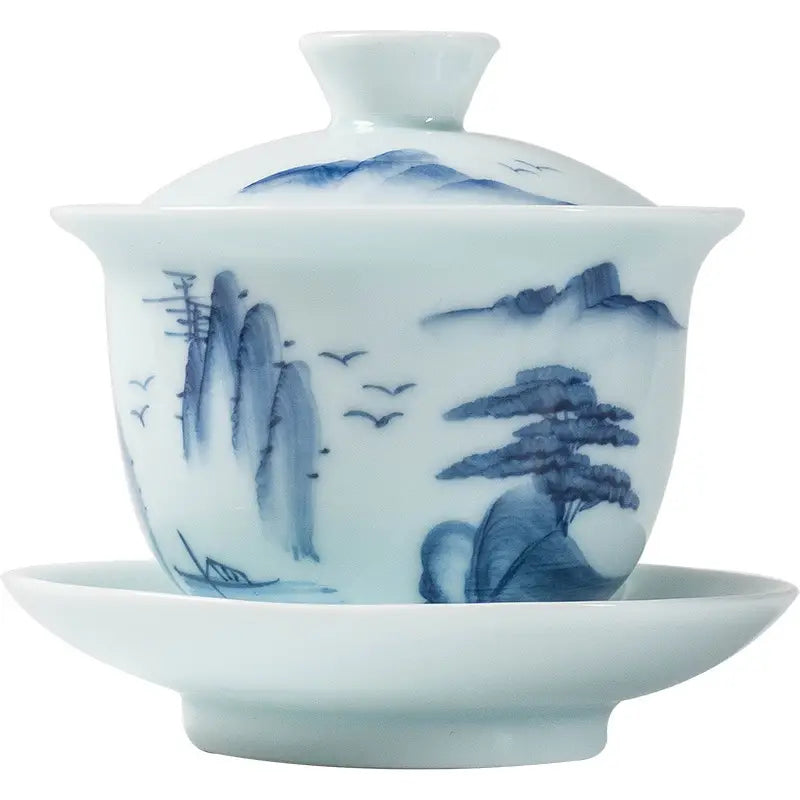 Blue and white porcelain Gaiwan showcasing Jingdezhen enamel art with mountain landscape design