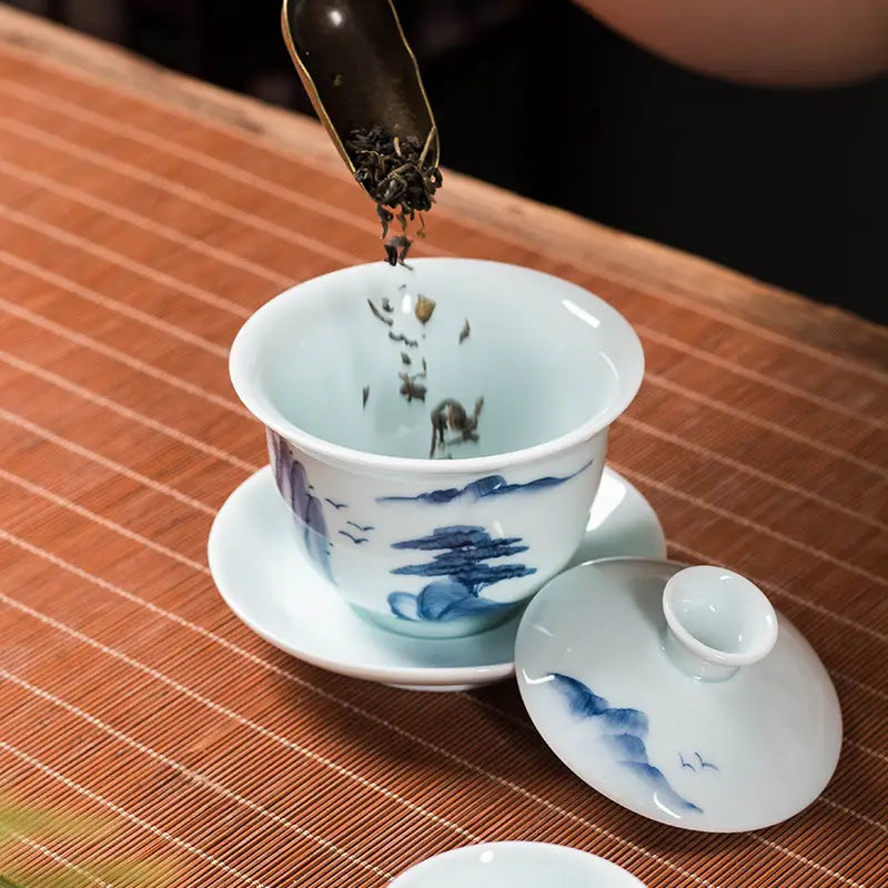 Blue and white tea set showcasing Landscape Gaiwan with Jingdezhen enamel art of mountain landscape