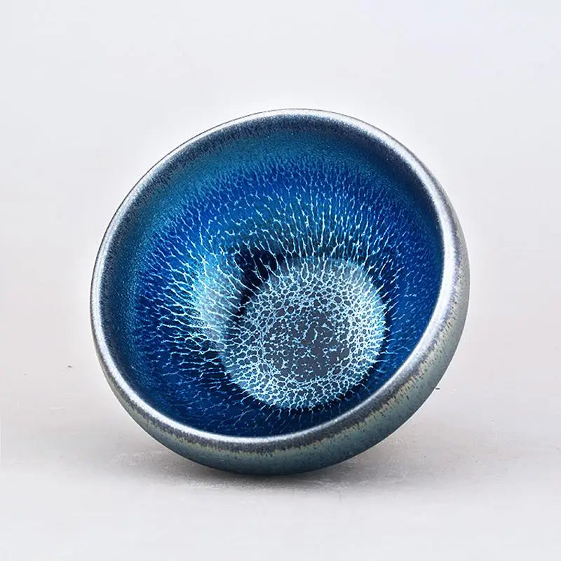 Blue ceramic bowl with crackled glaze inspired by Laser Jian Zhan, Tenmoku tradition, perfect for tea moments
