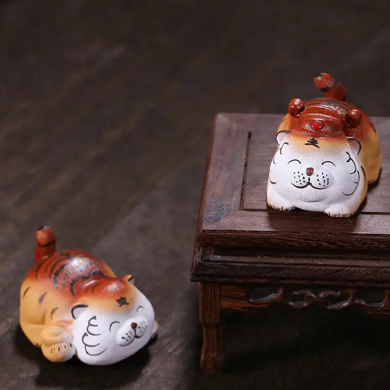 Laughing Fortune Tiger tea pet guide featuring two zisha clay figurines