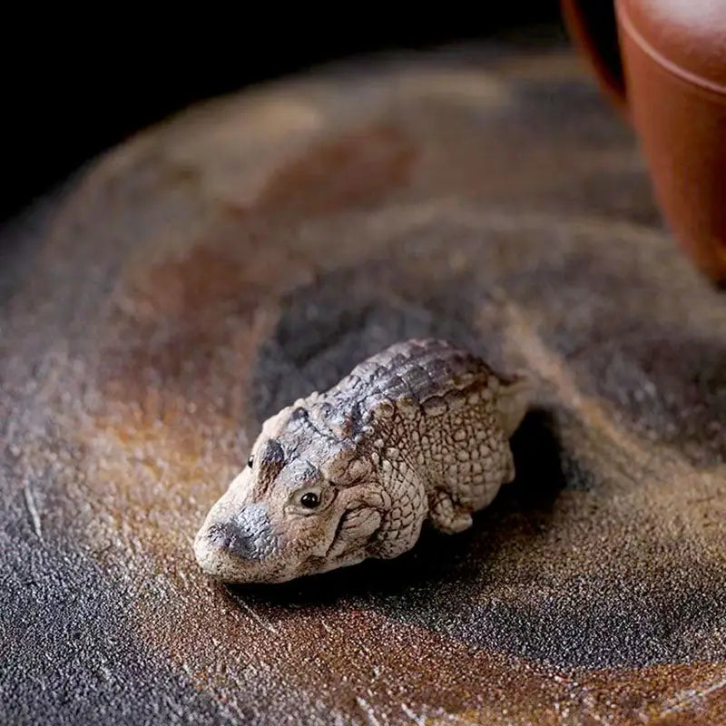 Miniature crocodile figurine as a crocodile tea pet made from Yixing Zisha clay for feng shui
