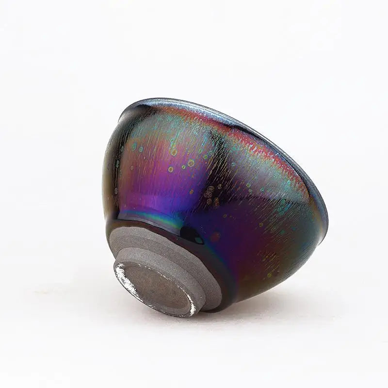 Iridescent ceramic tea bowl with tenmoku glaze in a jian zhan teacup style, deep violet finish