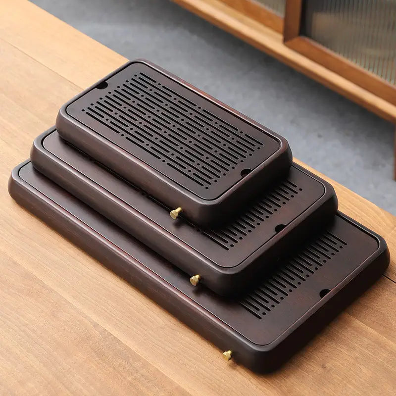 Stacked brown wooden bamboo tea tray set from Linear Harmony for elegant tea serving