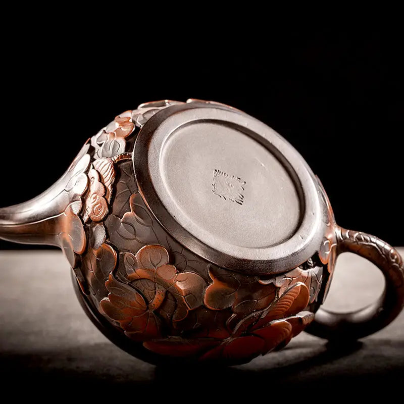 Ornate brown teapot with floral carvings from Lotus Flower Jianshui, ideal for gongfu tea enthusiasts