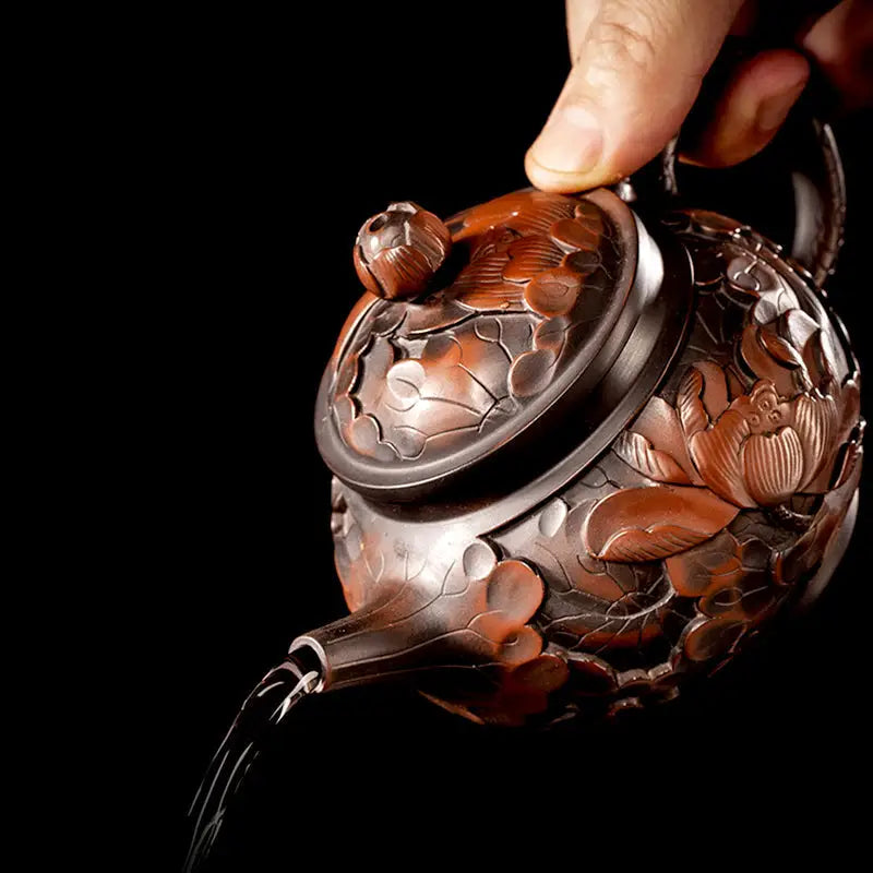 Ornate brown teapot pouring liquid, Lotus Flower Jianshui hand-carved lotus for gongfu tea enthusiasts