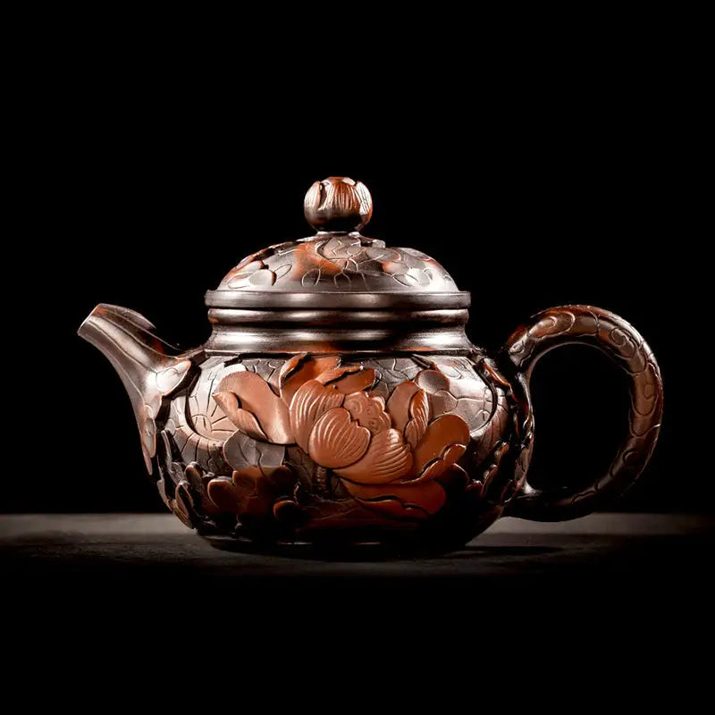 Ornate dark brown Jianshui teapot with hand-carved lotus flower floral carvings for gongfu tea enthusiasts