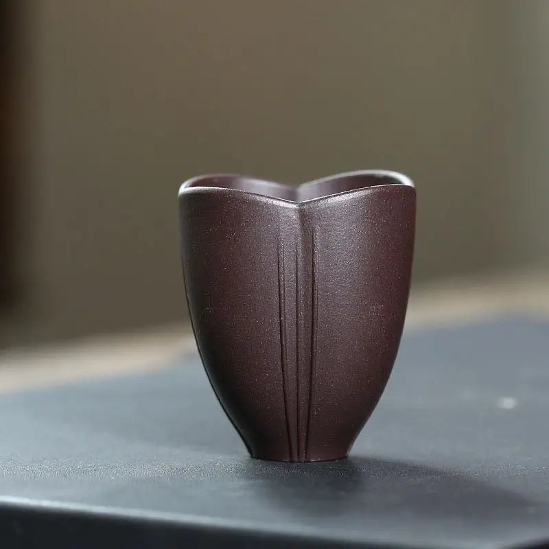 Brown ceramic tea cup from Lotus Heart showcasing authentic Yixing heart Zisha cup craftsmanship
